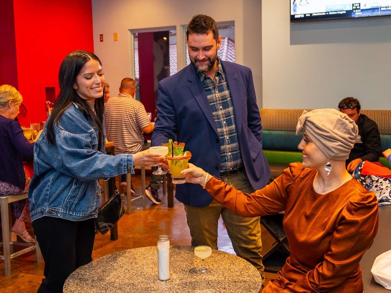3 People clinking drinks